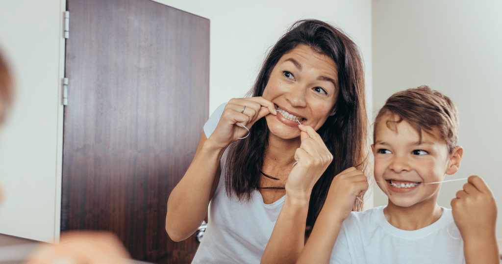 Woman and child flossing.