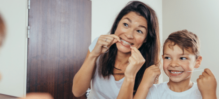 Woman and child flossing.