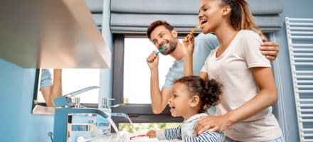 Family brushing teeth for natural dental care
