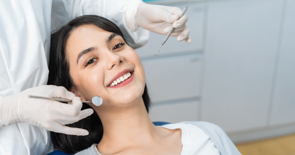 Woman smiling at a dental checkup.