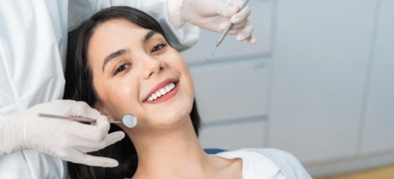 Woman smiling at a dental checkup.