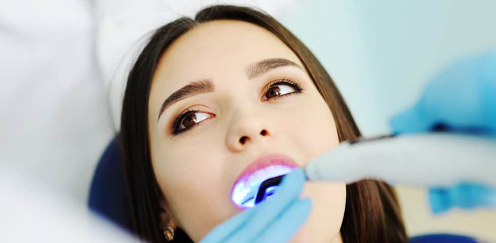 Woman having laser dental work done to fix silver fillings