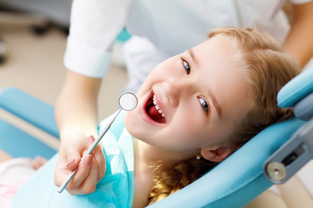 Happy child in an anchorage dental appointment