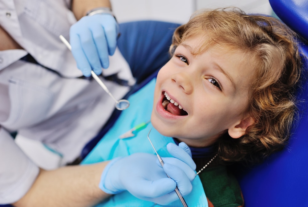 Child at the dentist getting his teeth preserved