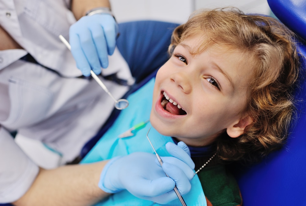 Child at the dentist getting his teeth preserved