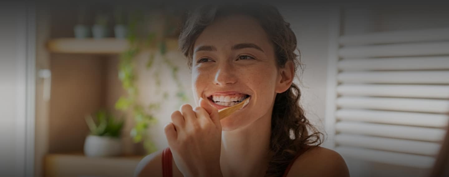 Girl brushes beautiful teeth from restorative dentistry services in Alaska